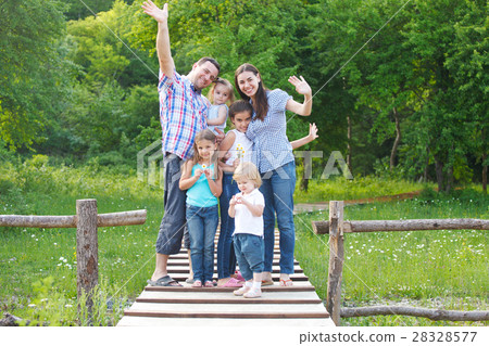Happy young family with four children Happy young family with four children 28328577