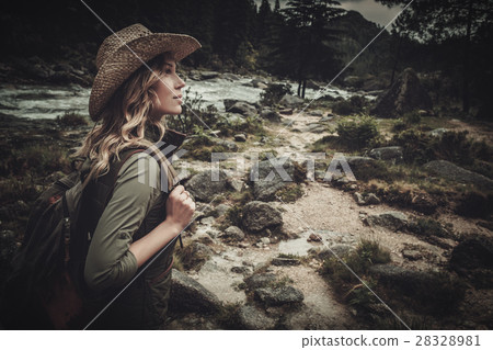 Beautiful woman hiker near wild mountain river. Beautiful woman hiker near wild mountain river. 28328981