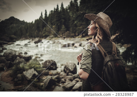 Beautiful woman hiker near wild mountain river. Beautiful woman hiker near wild mountain river. 28328987