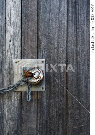 Rusty lock on the old wooden door Rusty lock on the old wooden door 28329447