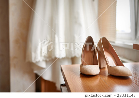 wedding shoes and bride in a bedroom wedding shoes and bride in a bedroom 28331145