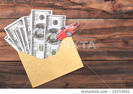 Money in envelope on wood. 28333602