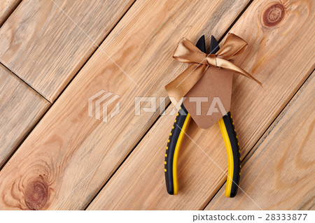 Pliers and blank greeting card. 28333877