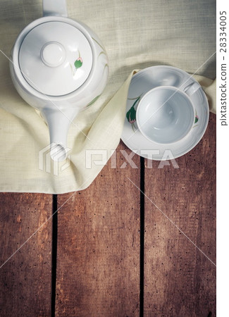 Kettle with cup on table Kettle with cup on table 28334005