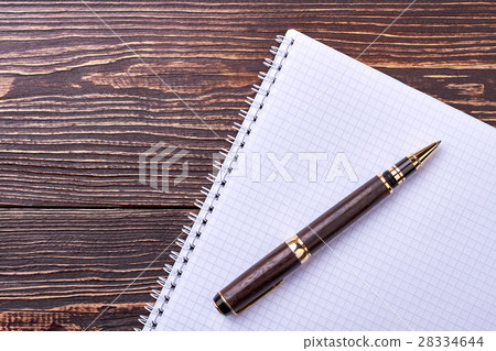 Notebook and pen on wood. Notebook and pen on wood. 28334644