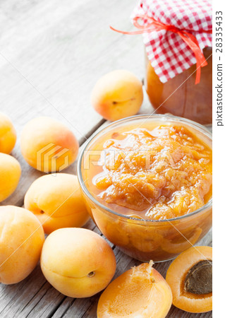 jar of jam and ripe apricot fruits on table jar of jam and ripe apricot fruits on table 28335433