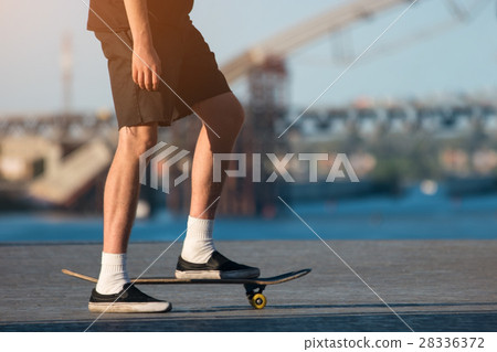 Person with skateboard outdoor. Person with skateboard outdoor. 28336372