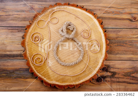 8-shaped rope on trunk slice. 28336462