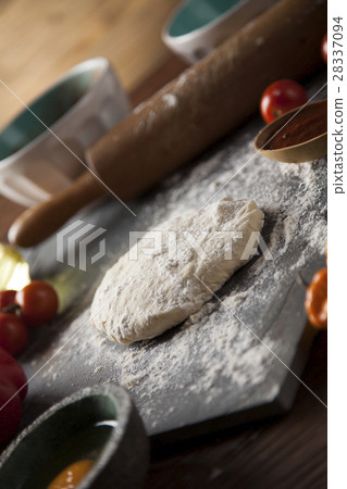 Preparing pizza with dough and tomato sauce Preparing pizza with dough and tomato sauce 28337094