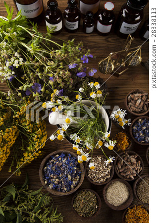 Herbs, berries and flowers with mortar, on wooden  28338113