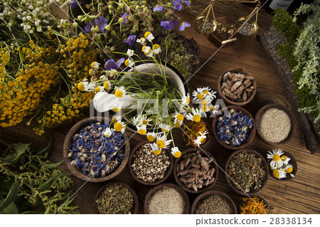 Healing herbs on wooden table, mortar and herbal  28338134