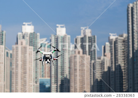 Drone doing surveillance photographing cityscape 28338363