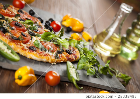 Tasty pizza, tomatoes and others ingredients  28338485