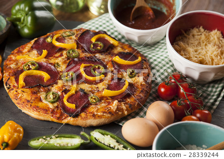 Tasty pizza, tomatoes and others ingredients Tasty pizza, tomatoes and others ingredients 28339244
