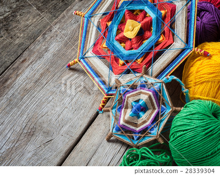 Knitted mandala and yarn on rustic table Knitted mandala and yarn on rustic table 28339304
