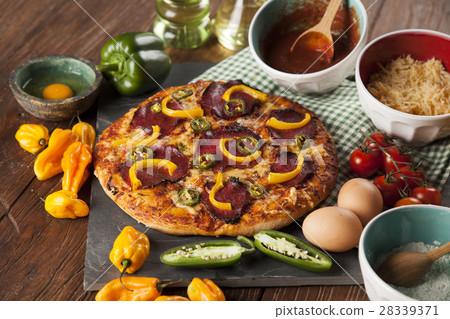 Delicious pizza served on wooden table Delicious pizza served on wooden table 28339371