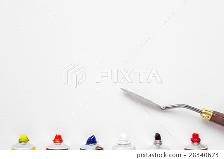 palette knife and oil paint tubes on white canvas 28340673