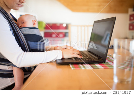Unrecognizable mother with son in sling, writing Unrecognizable mother with son in sling, writing 28341937