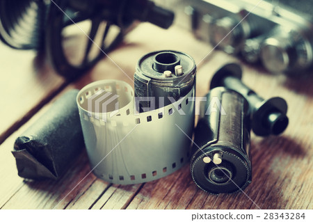 Old photo film rolls, cassette and retro camera. Old photo film rolls, cassette and retro camera. 28343284