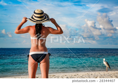Woman and tropical beach in the Maldives. Woman and tropical beach in the Maldives. 28344407