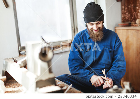 A man working with woodcarving instruments 28346334
