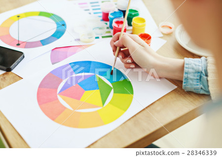 Woman's hands with white manicure drawing 28346339