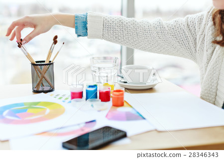 Woman's hands with white manicure touching paint Woman's hands with white manicure touching paint 28346343