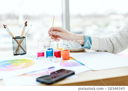 Woman's hands with white manicure drawing 28346345
