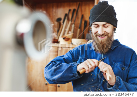 A man working with woodcarving instruments A man working with woodcarving instruments 28346477