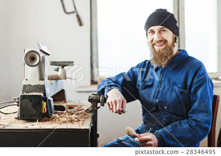 A man working with woodcarving instruments 28346495