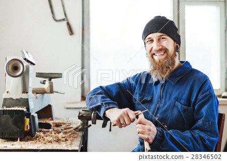 A man working with woodcarving instruments 28346502