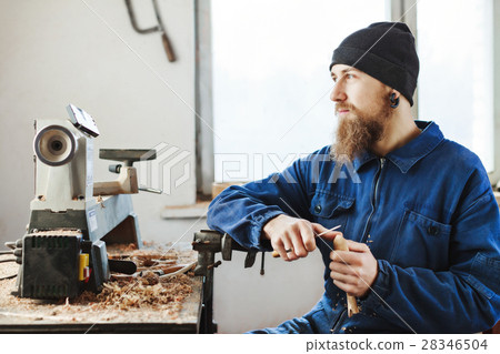 A man working with woodcarving instruments 28346504