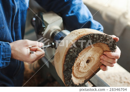 A man working with woodcarving instruments 28346704