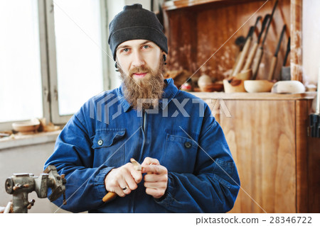 A man working with woodcarving instruments 28346722