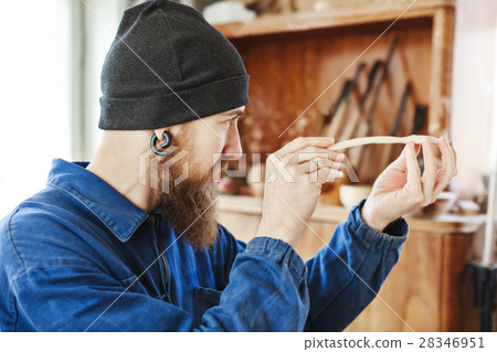 A man working with woodcarving instruments A man working with woodcarving instruments 28346951