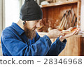 A man working with woodcarving instruments 28346968