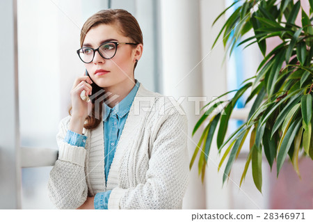Lovely girl with glasses standing with mobile Lovely girl with glasses standing with mobile 28346971