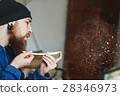 A man working with woodcarving instruments 28346973