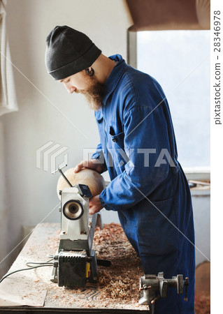 A man working with woodcarving instruments 28346978