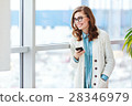 Lovely girl with glasses standing with mobile 28346979