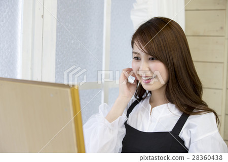 A young woman with a smile checking face and grooming while watching the mirror A young woman with a smile checking face and grooming while watching the mirror 28360438