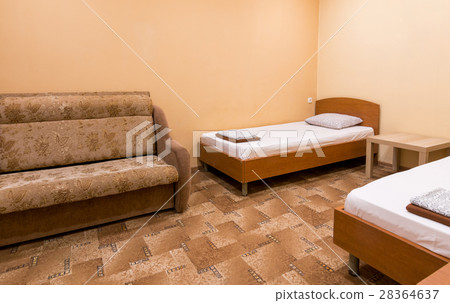 The interior of a small room with a sofa and two beds The interior of a small room with a sofa and two beds 28364637
