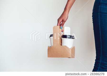 Woman holding a blank takeaway coffee cups white 28366270