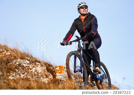 Mountain biker looking at inspiring mountain Mountain biker looking at inspiring mountain 28367222