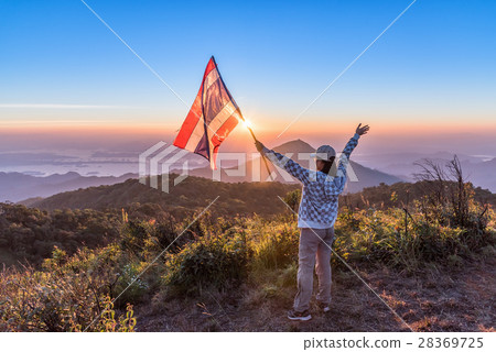 Woman standing on mountain and enjoy sunset view 28369725