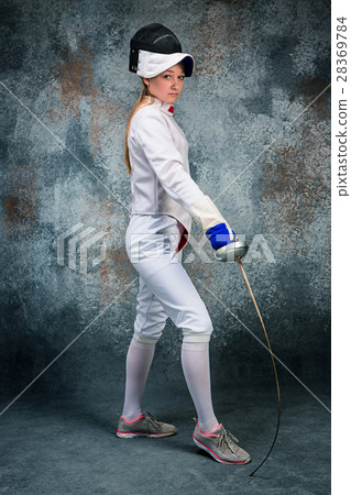 The woman wearing fencing suit with sword against The woman wearing fencing suit with sword against 28369784