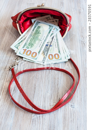 100 dollars banknotes fall out from red handbag 28370591