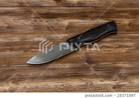 Hunting steel knife handmade on a wooden 28371897
