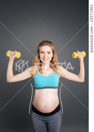 Nice smiling pregnant woman doing sport exercises Nice smiling pregnant woman doing sport exercises 28371901