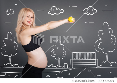 Cheerful pregnant woman training outdoors 28372005